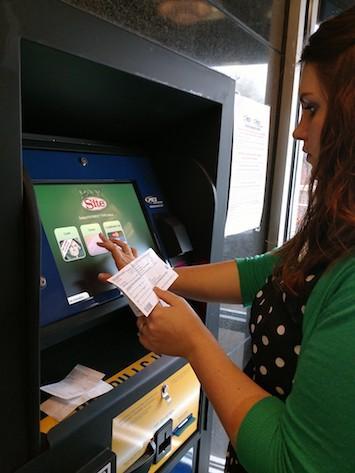 woman using PES Bill Pay Kiosk